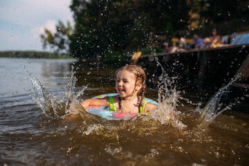 baby girl bathing in water, lake, splashes, summer, heat, children's smile, happiness
