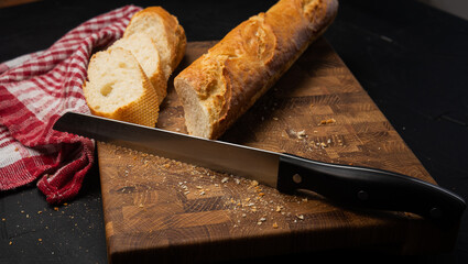 Bread knife on chopping board