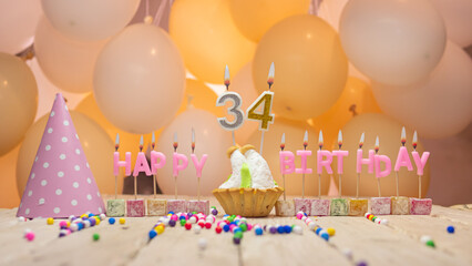 Beautiful background happy birthday number 34 with burning candles, birthday candles pink letters...