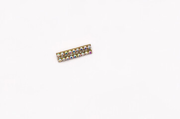 Rectangle golden brooch with crystals, isolated on white.