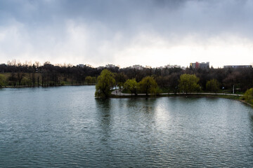 Landscape over the lake from Tineretului park in a cloudy day, Bucharest, Romania.