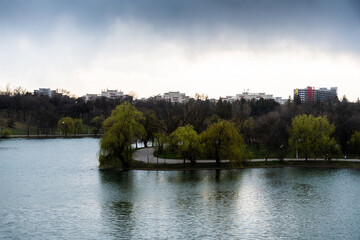 Fototapeta na wymiar Landscape over the lake from Tineretului park in a cloudy day, Bucharest, Romania.