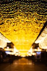 bright yellow illumination at night in the street, nice promenade pedestrian area, urban public...