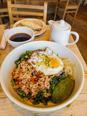Close up shot of oat rice with nuts and sunny egg