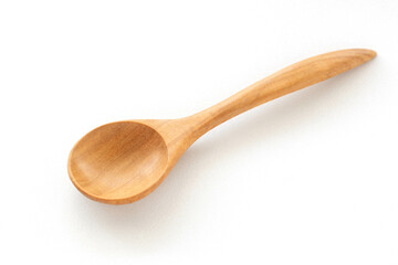 A wooden spoon is placed on a white ceramic background. Concept of isolated objects on a white background. Shot in natural light.