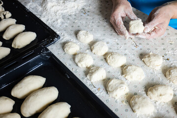Womans hands rolling the dough for pies. Baking at home