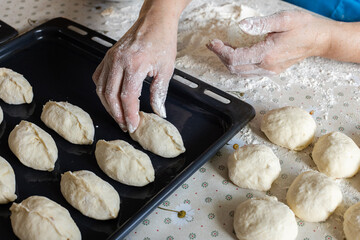  Woman cooking pies at home. Cooking and baking at home.