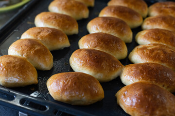 Pies just from oven on a baking tray. Closeup, selective focus.