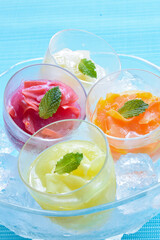 Fototapeta na wymiar Four kind of Fruits Sorbet with ice in the bowl, Summer image, Blue background