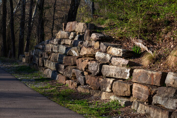Rock wall next to a path in the park