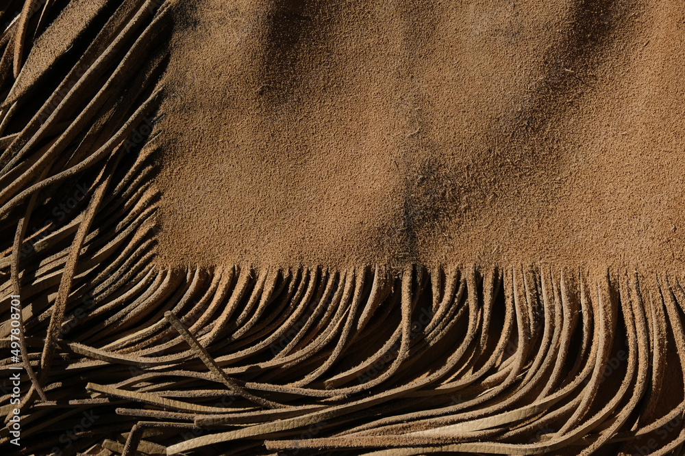 Poster western industry leather background shows armitas leather with fringe. - Posters