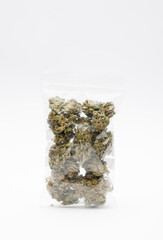 Plastic hermetic bag with set of marijuana buds, white background. Space for text