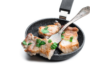 Fried pork slices in frying pan isolated on white