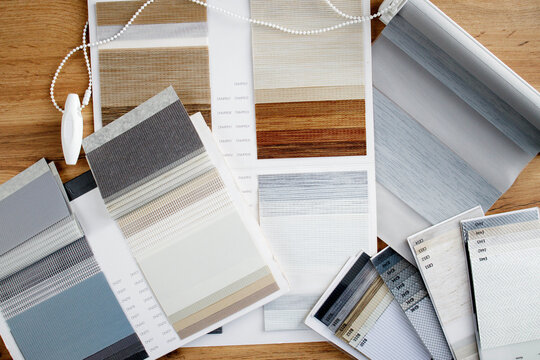 Samples of fabrics of different textures and colors in the form of a catalog for the selection of fabrics for fabric blinds. Samples of blinds day and night.