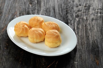 Choux Cream Cake Traditional French Dessert on White Plate