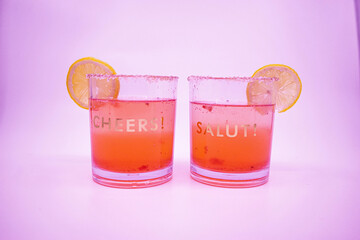 Summer Raspberry Lemon Cocktail Mix with lemon slices on glasses with Cheers and Salut