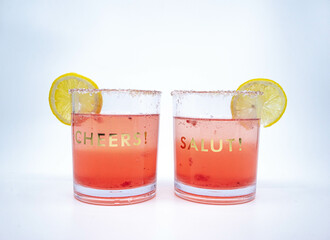 Summer Raspberry Lemon Cocktail Mix with lemon slices on glasses with Cheers and Salut