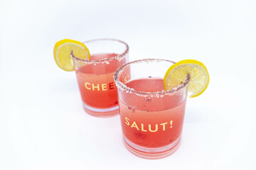 Summer Raspberry Lemon Cocktail Mix with lemon slices on glasses with Cheers and Salut