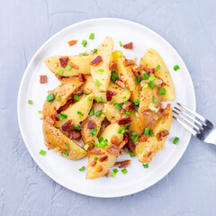Bacon and onion potato salad with apple cider vinegar and mustard, on plate, square format