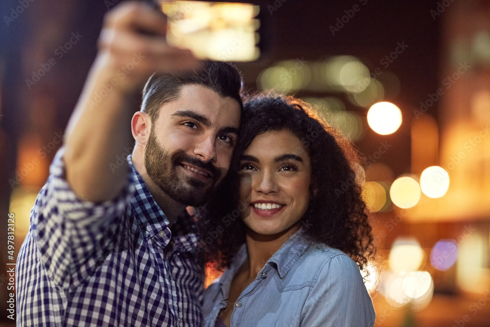 Poster memories are made of this. shot of an affectionate young couple taking a selfie while out on a date 