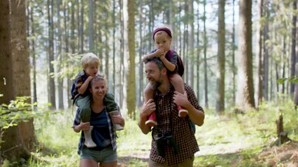 Family with small children walking outdoors in summer nature. - Powered by Adobe
