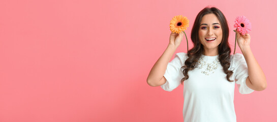 Beautiful happy young woman with flowers on pink background with space for text. Hello spring