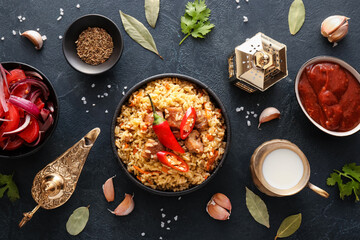 Bowl of traditional pilaf and Arabic lamps on dark background