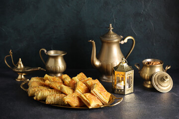 Tray with tasty Turkish baklava on dark background