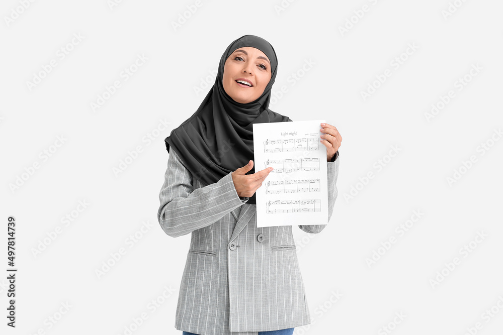 Sticker Muslim music teacher with note sheets on light background