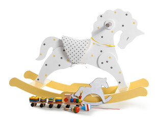 Rocking horses and wooden toys on white background