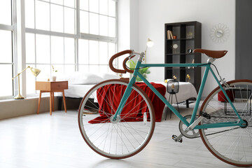Fototapeta na wymiar Interior of modern stylish bedroom with bicycle