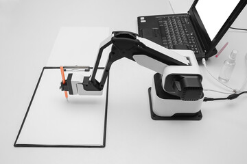 Futuristic robotic arm with pen and blank paper sheet at exhibition