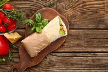 Board of tasty burrito with meat on wooden background