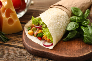 Board of tasty burrito with meat on wooden background - obrazy, fototapety, plakaty