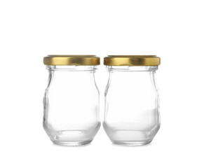 Empty glass jars with golden caps on white background