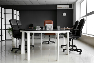 Large table and chairs in stylish conference hall interior