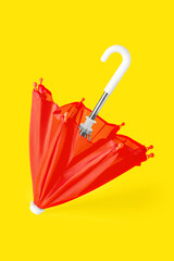 Red umbrella on yellow background