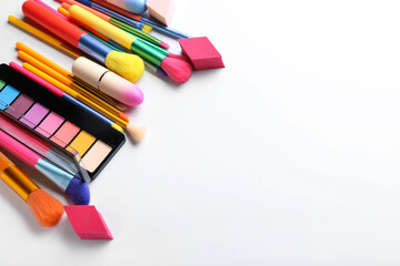 Naklejka premium Different cosmetics and makeup brushes isolated on white