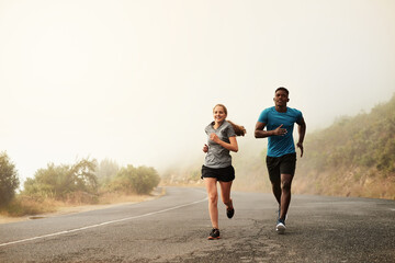 Sprint towards your goals. Shot of two sporty young people out for a run together.