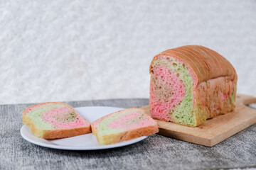 Rainbow bread loaf slice on a white background.	
