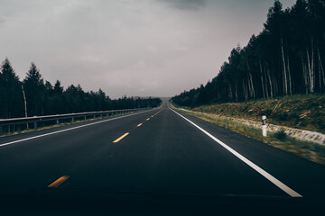 car driving on the asphalt road, dark background.