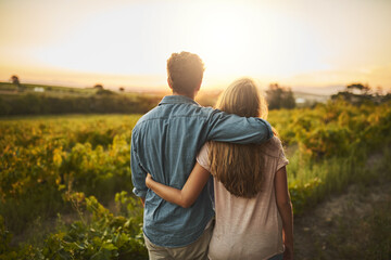 Look at what weve accomplished. Shot of a young couple walking through their crops while holding each other and looking into the horizon. - Powered by Adobe