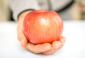 hand holding apple pie with heart shape, concept of love
