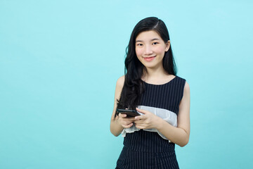 Surprised young Asia lady using mobile phone with positive expre