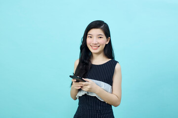 Surprised young Asia lady using mobile phone with positive expre