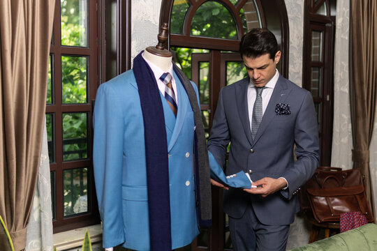 Handsome man in elegant classic suit, tailor store.