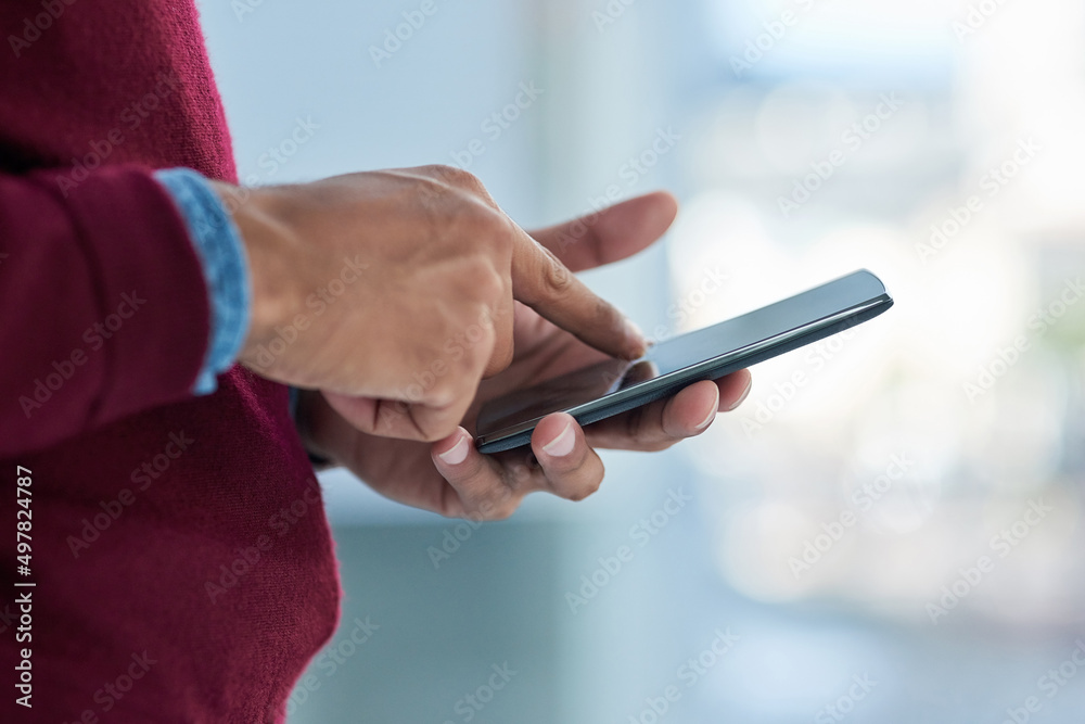Poster his office is wherever he is. shot of an unidentifiable businessman using his smartphone in the offi