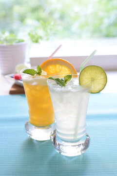 Summer Concept, Orange soda and lime soda with mint at the window