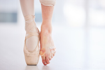 I should definitely tape my feet more often. Cropped shot of a young ballerina wearing a pointe shoe on one foot and band aids on her barefoot. - obrazy, fototapety, plakaty