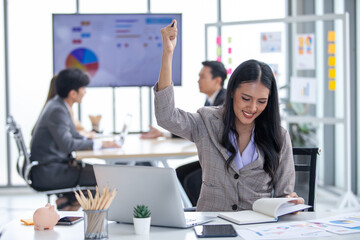 Portrait of Asian beautiful business woman working laughing and rejoicing, smiling at the office, using computer on table.